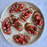 strawberry basil bruschetta on a plate.