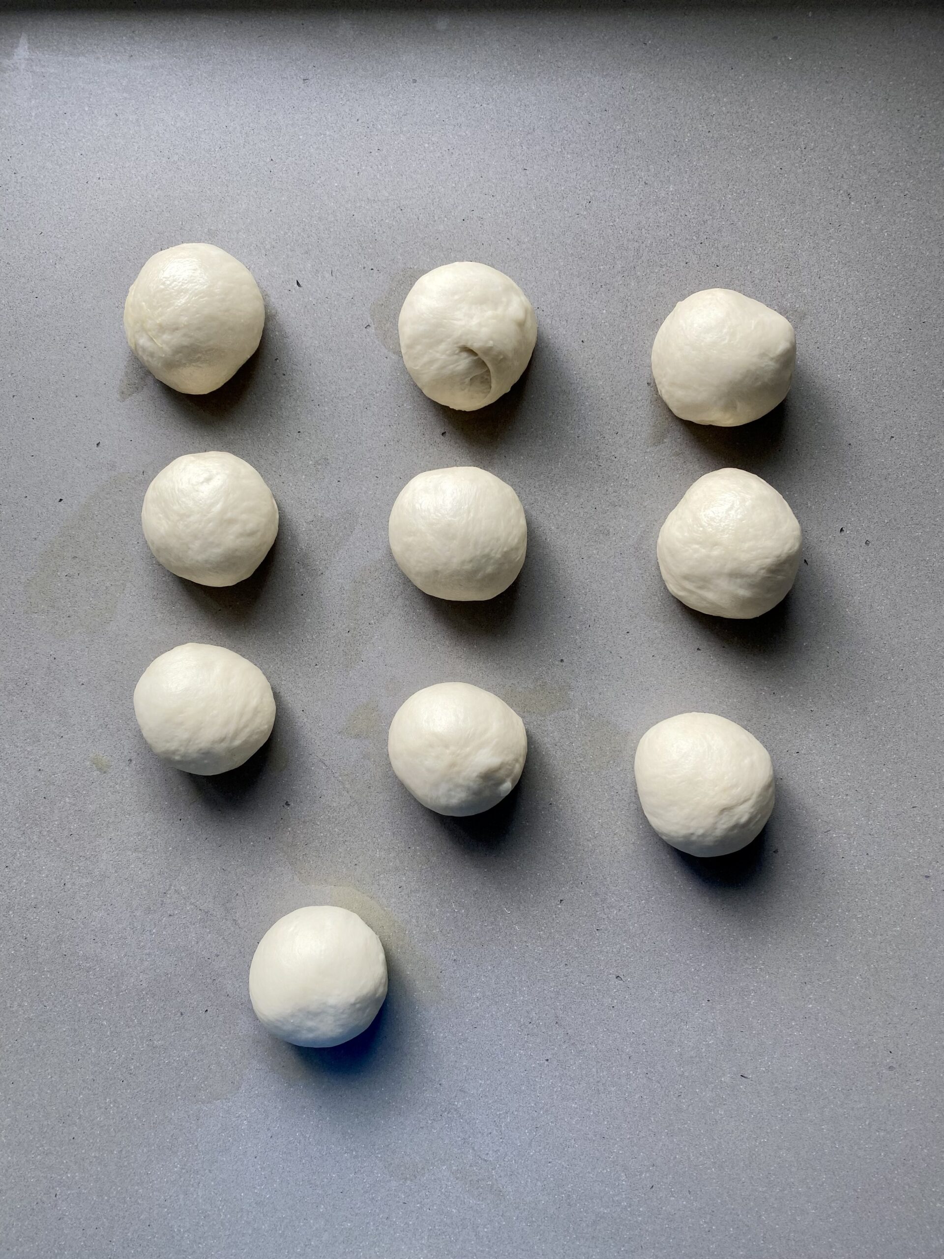 10 small dough balls on the counter.