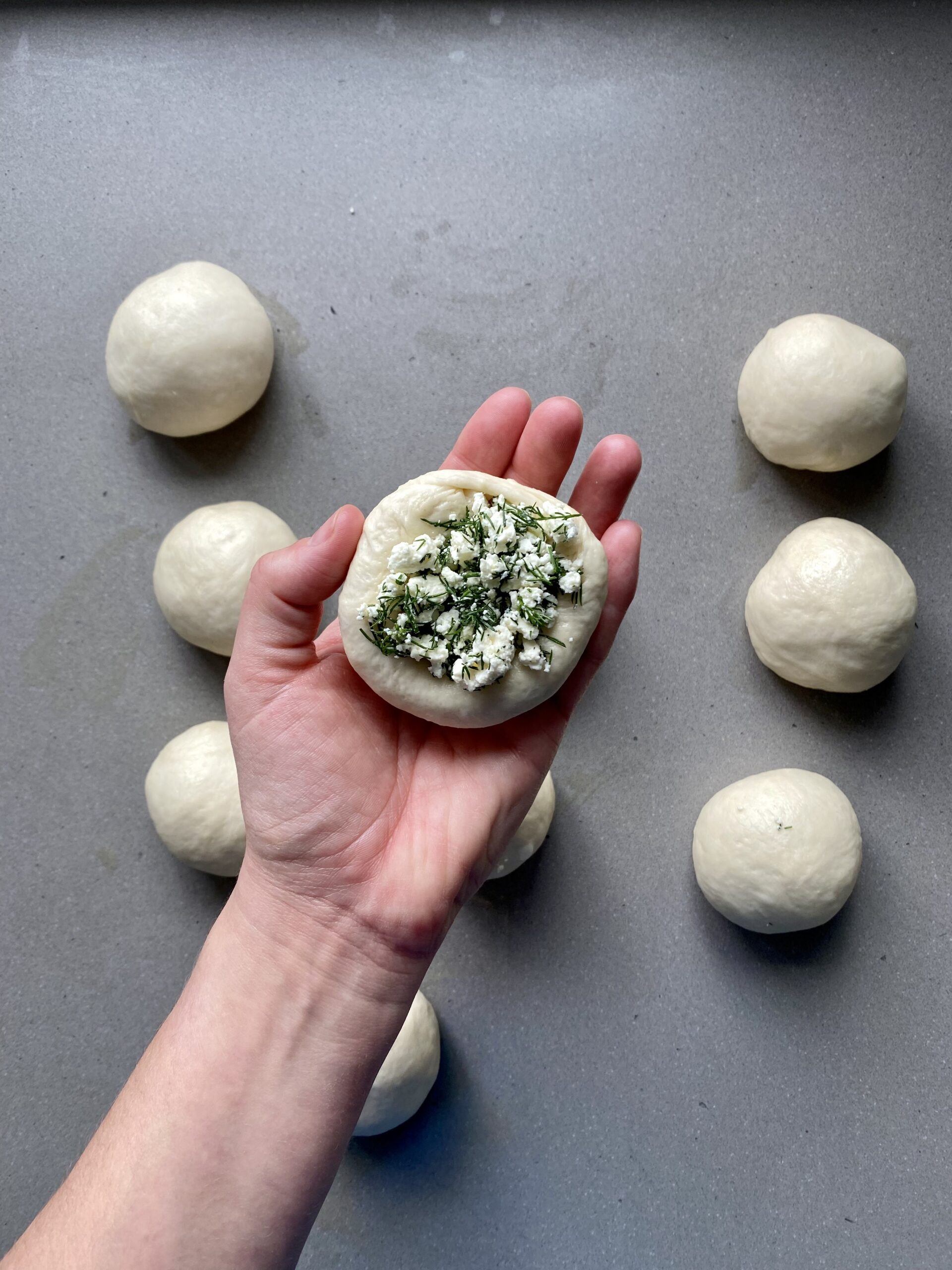 one dough ball filled with feta and dill.