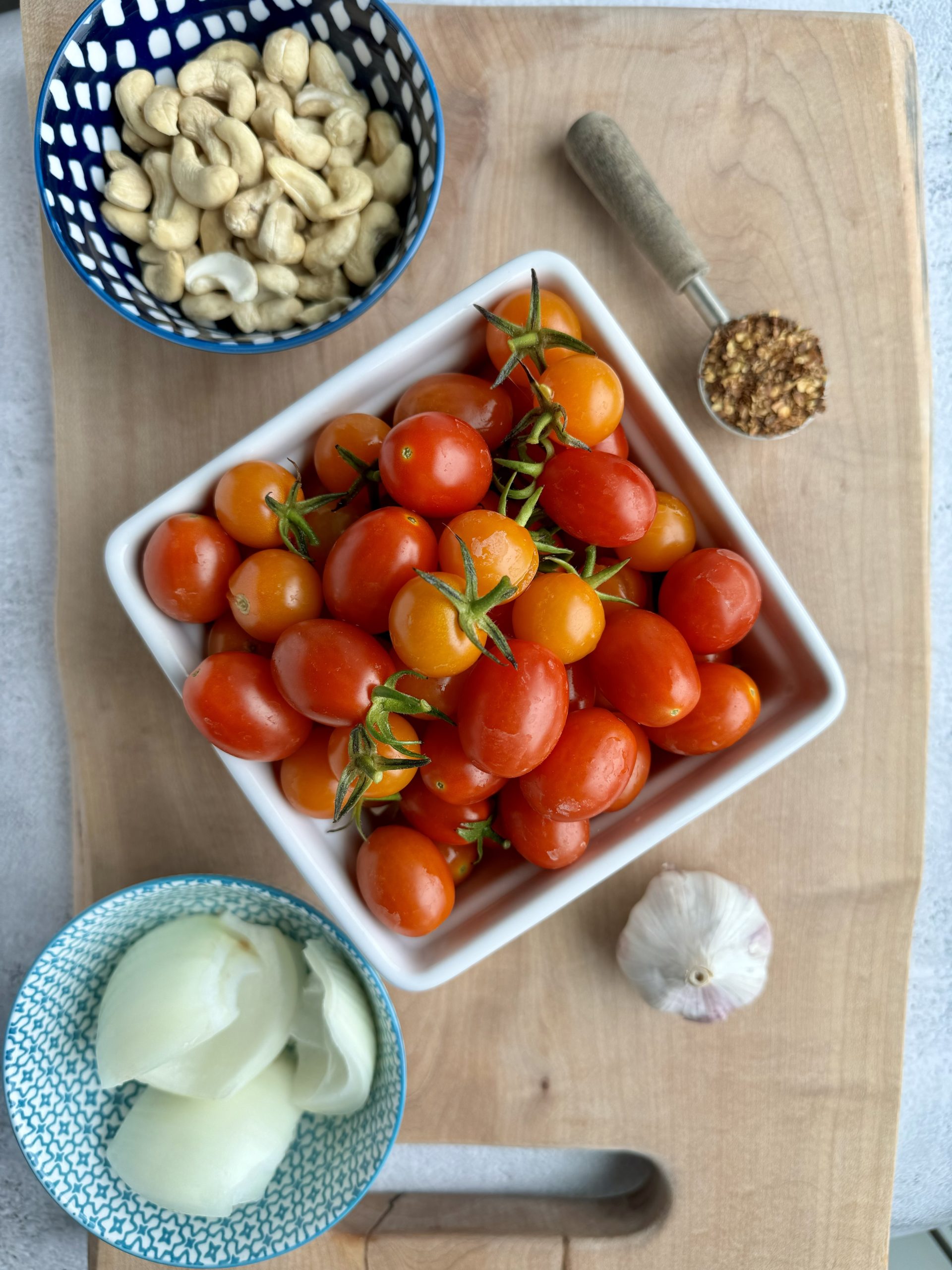 creamy roasted tomato sauce ingredients on a cutting board