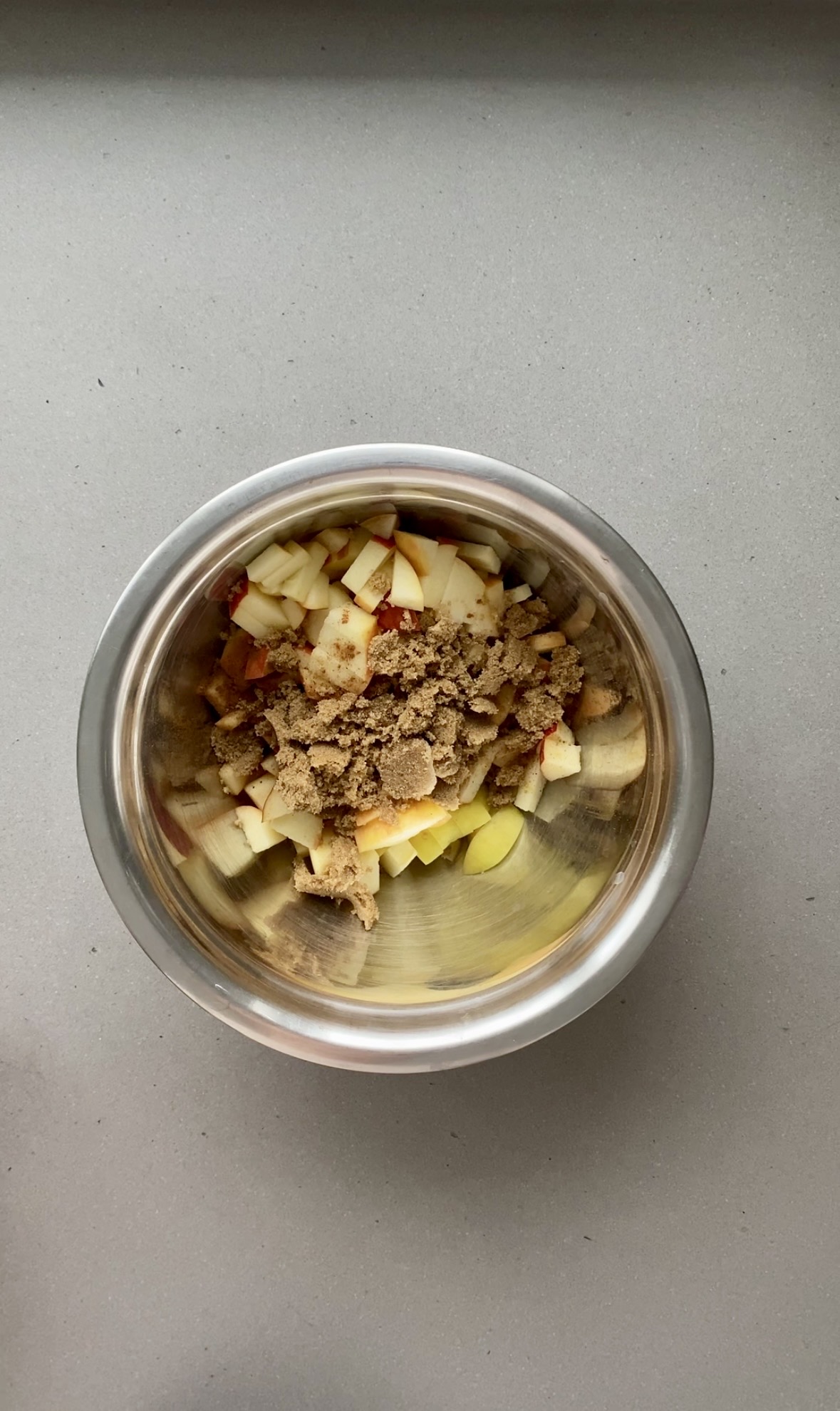 diced apples and pears with brown sugar and spices in a small bowl.
