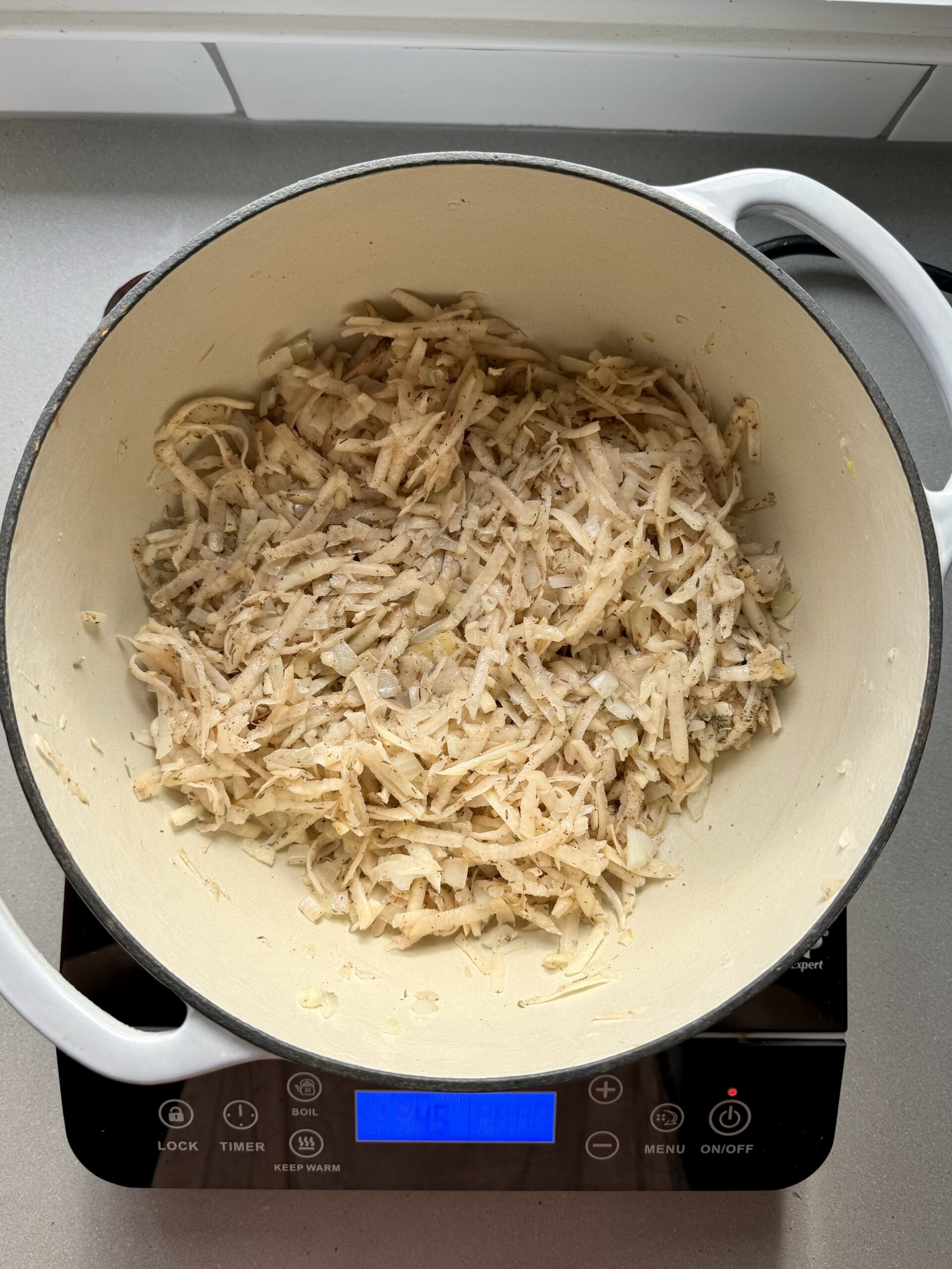 shredding potatoes cooking in a large pot.
