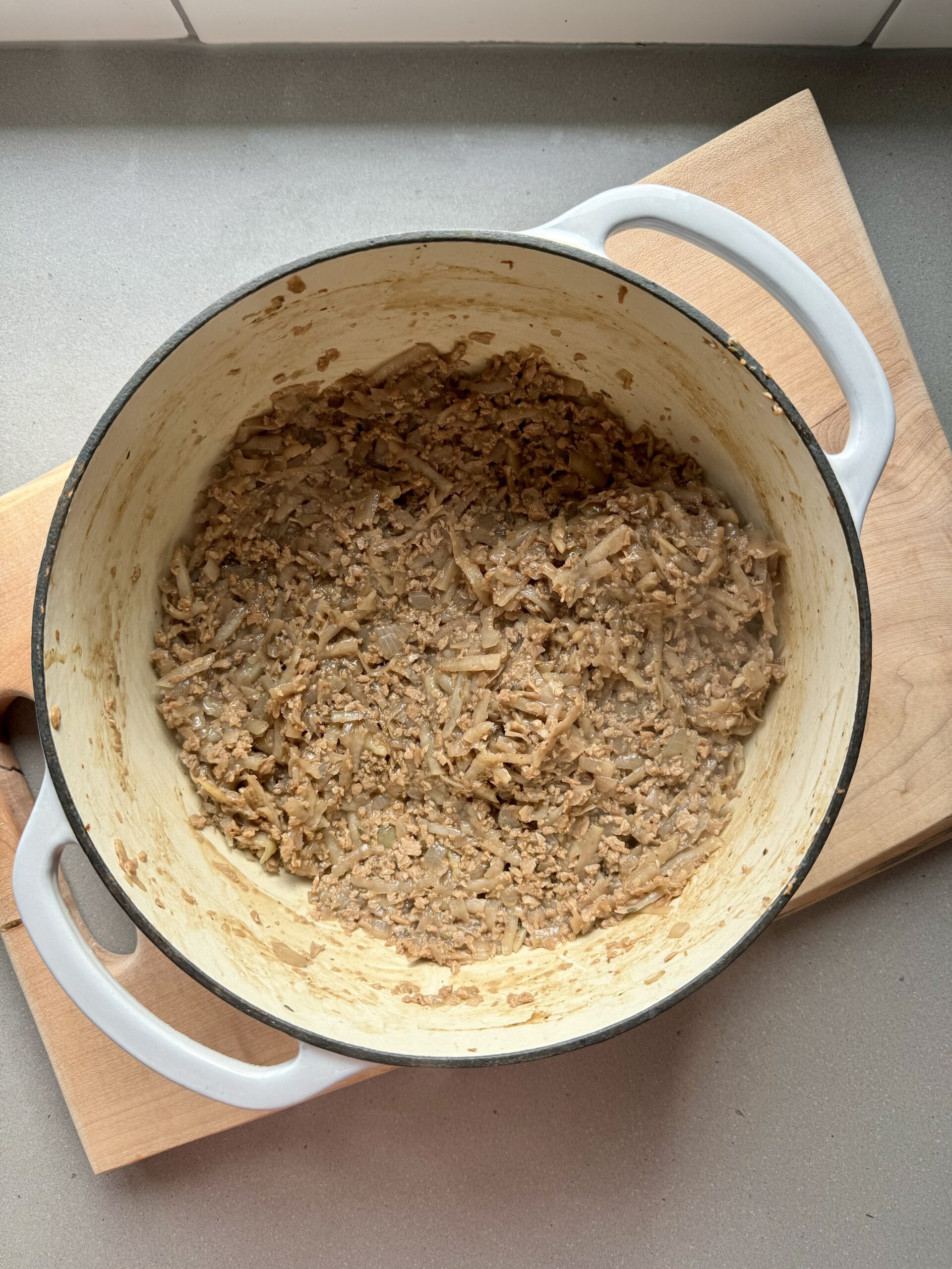 shredded potatoes and TVP done cooking and cooking in a large pot.