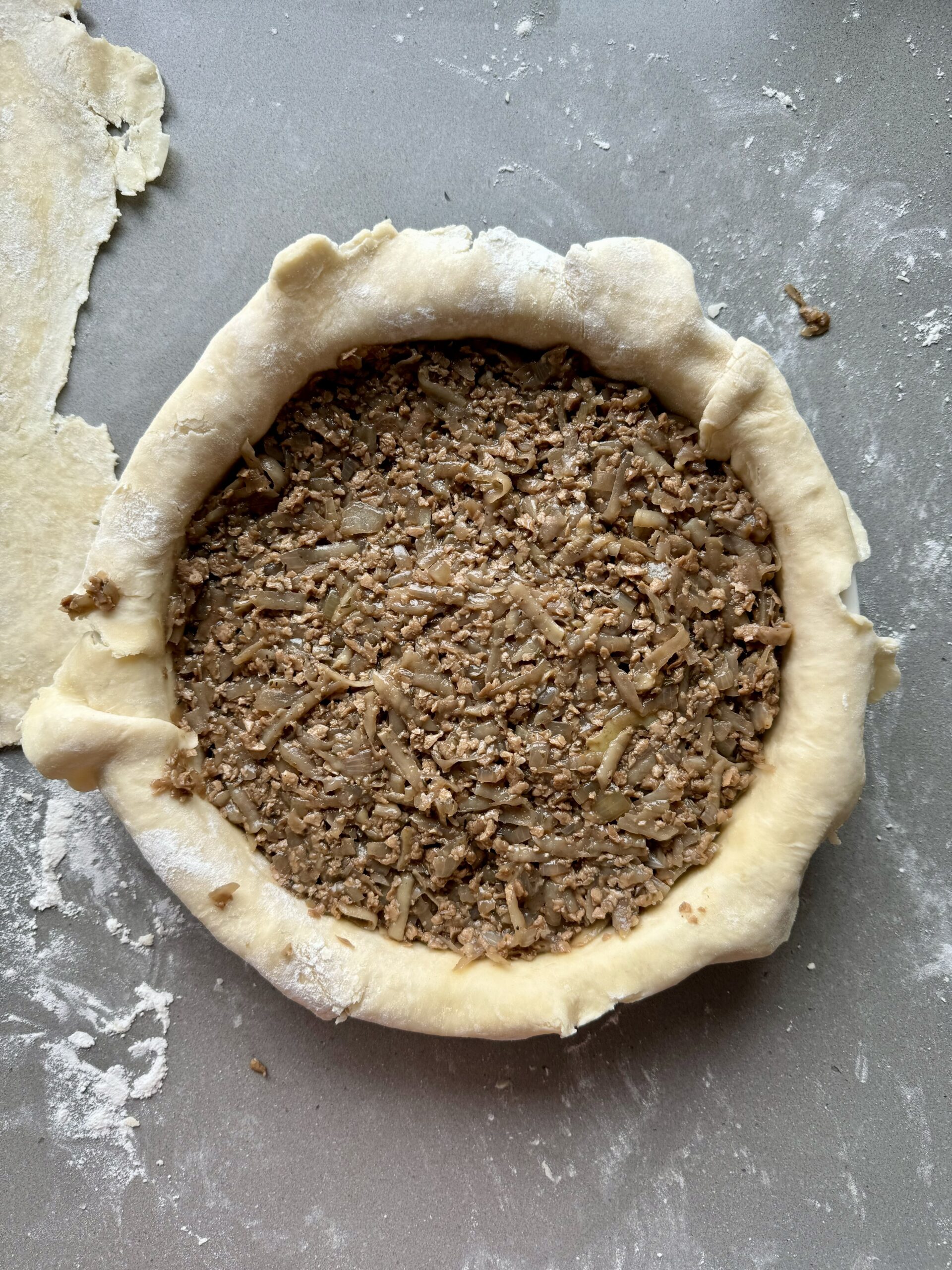 vegan meat pie filling added to the bottom pie layer.