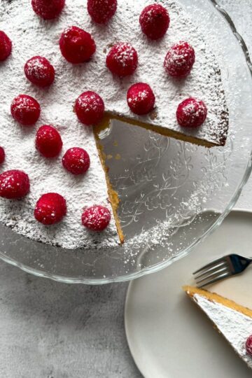 almond cake with fresh raspberries on top.