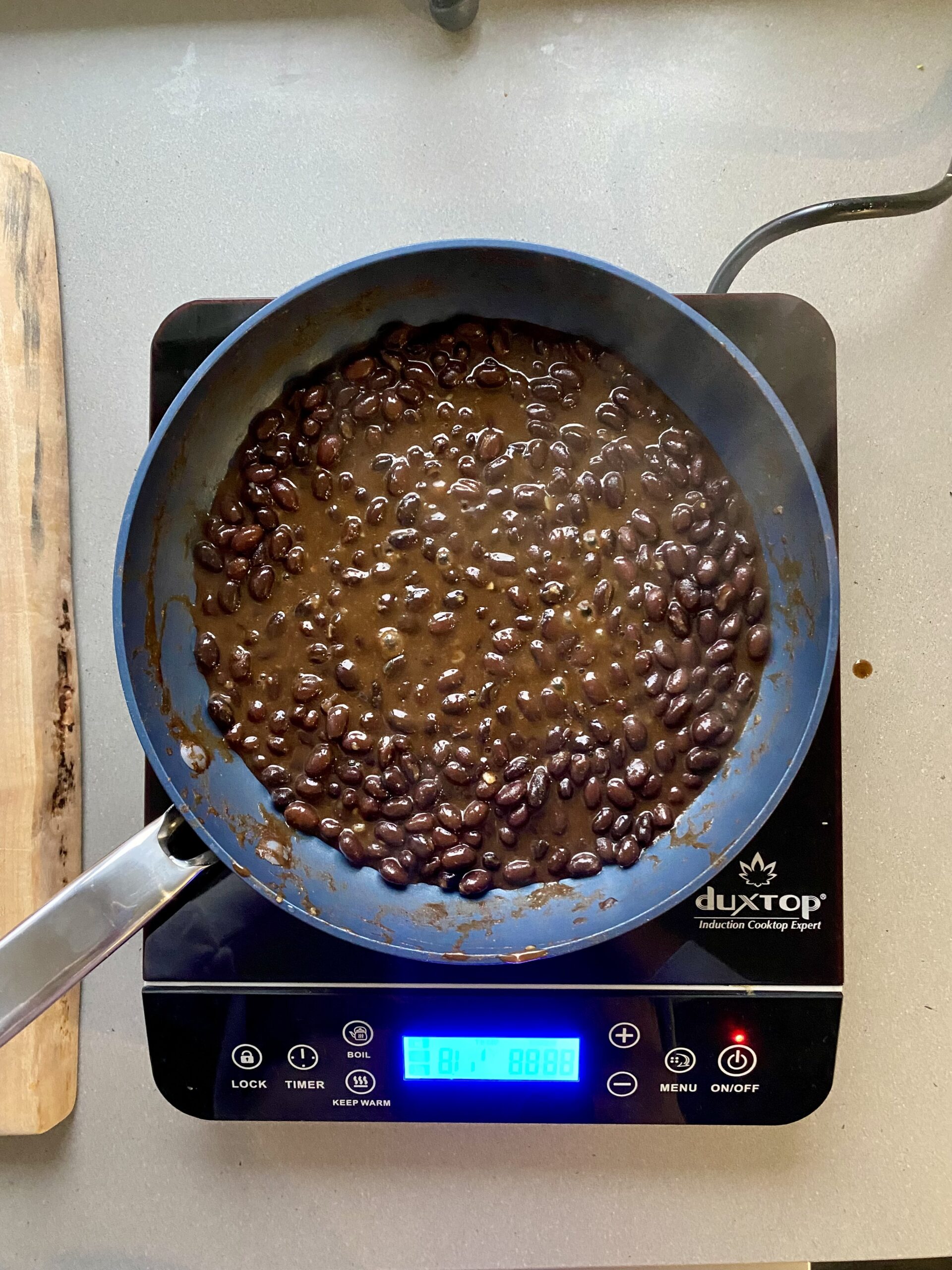 canned black beans cooking in a pan.