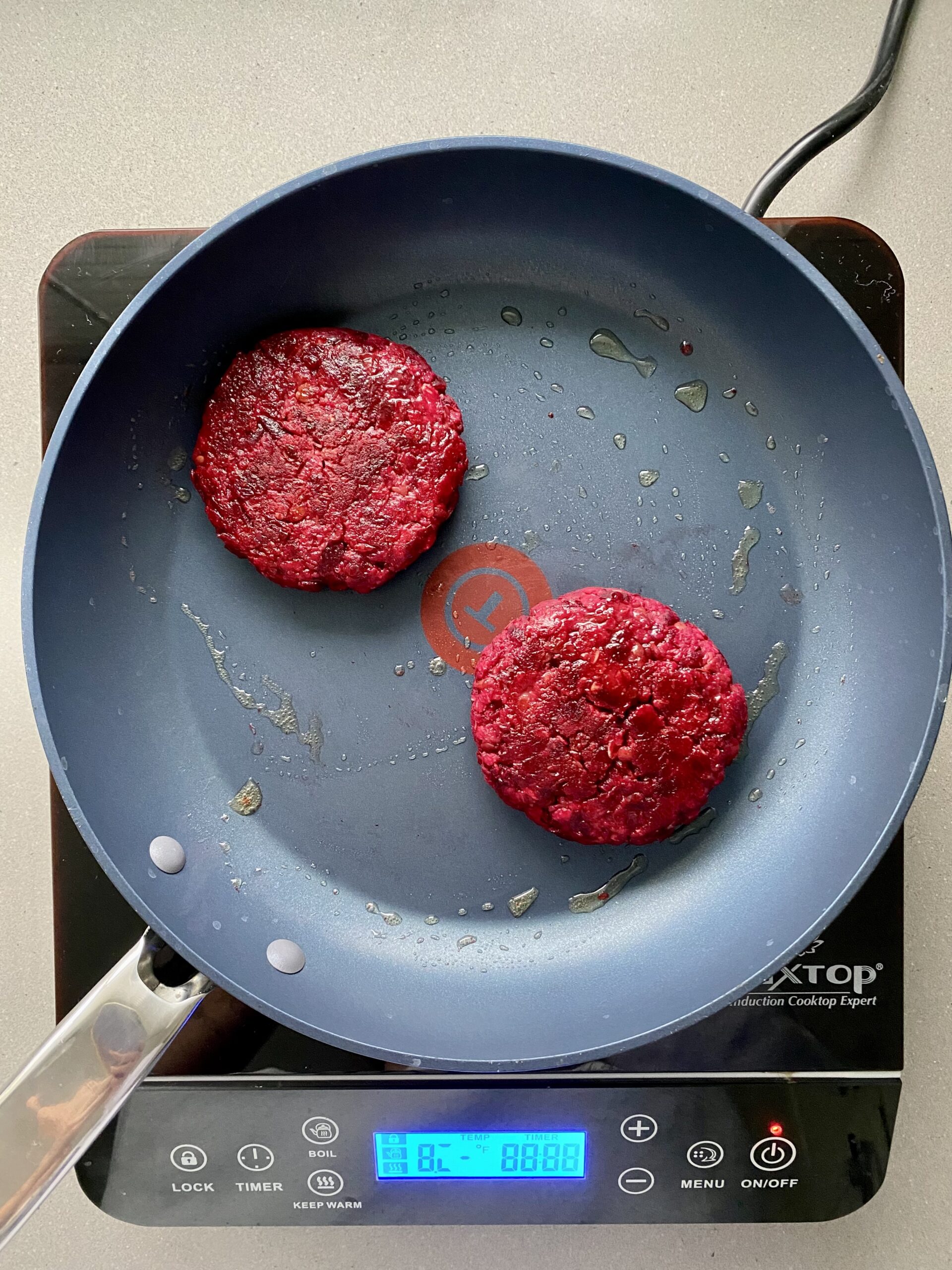 beet burger patties on a pan, cooked.