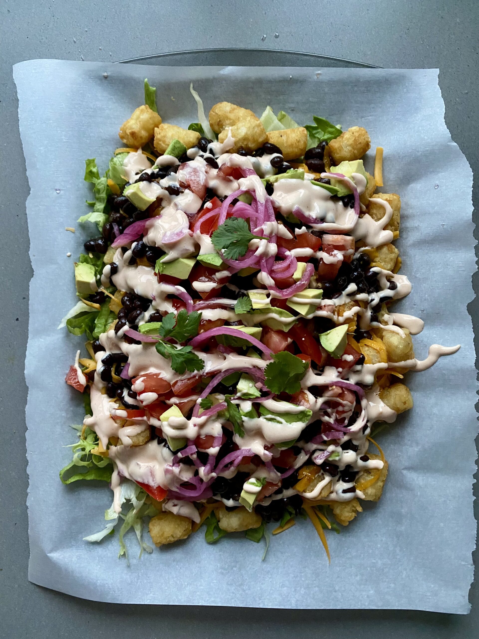 drizzled sauce and fresh cilantro on the tater tots.