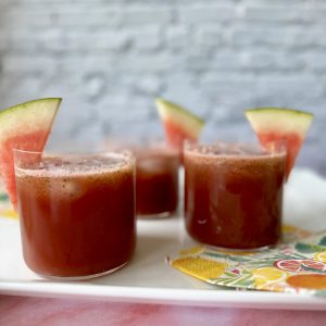 watermelon mint refresher in four glasses with watermelon garnish