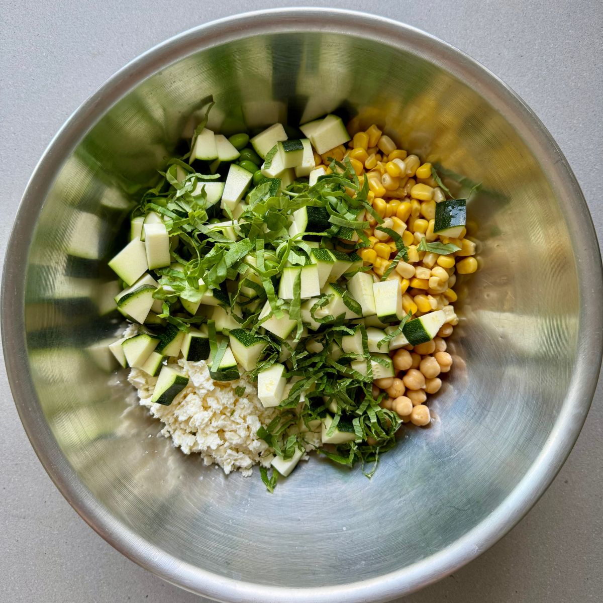 edamame lentil salad ingredients in a large bowl.
