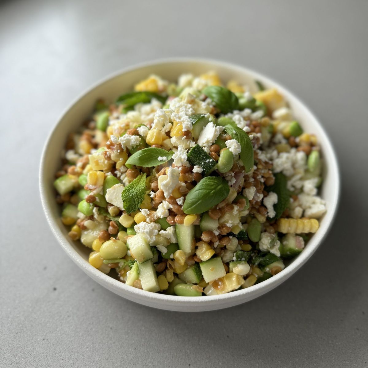 edamame lentil salad in a white bowl.