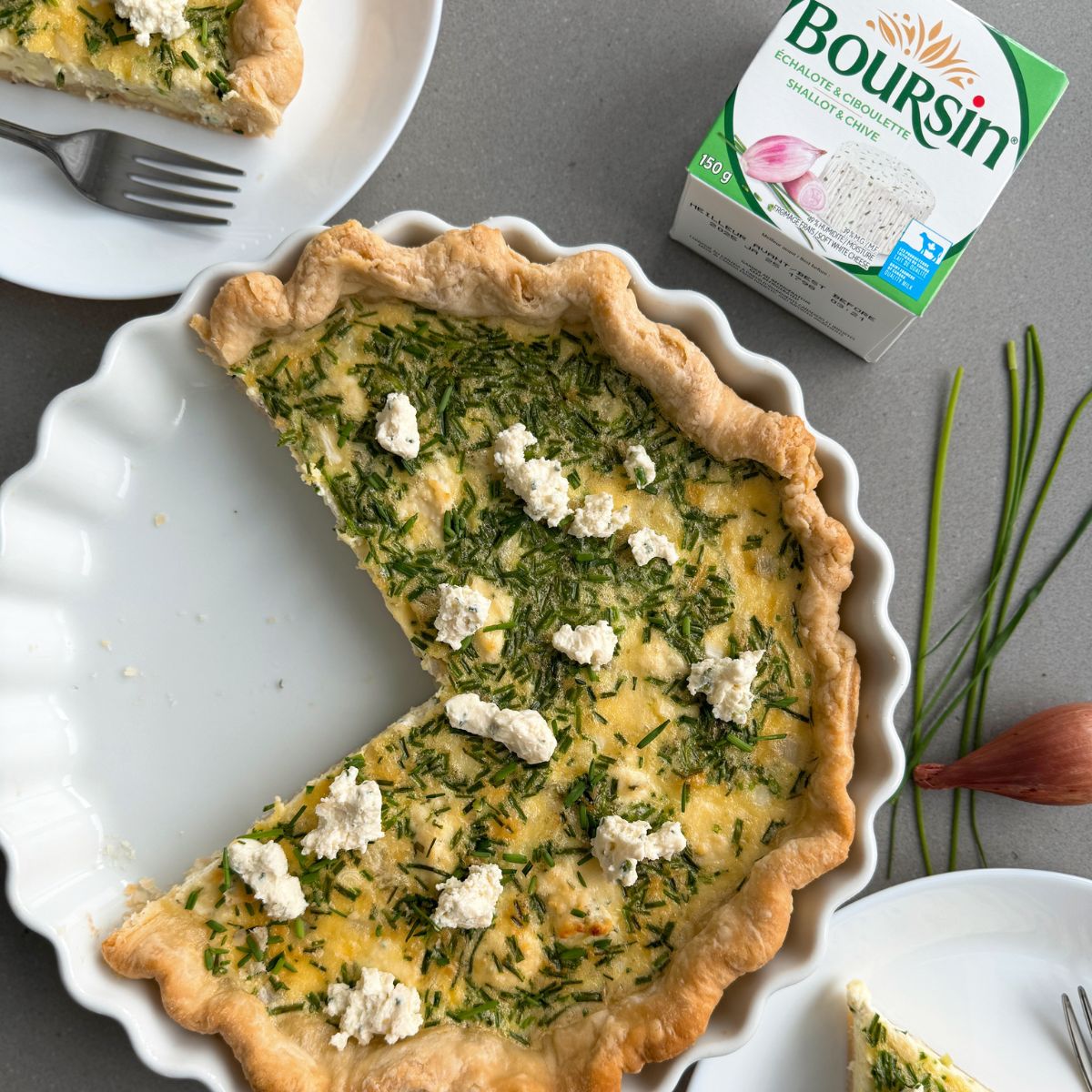 boursin quiche in a white serving plate.