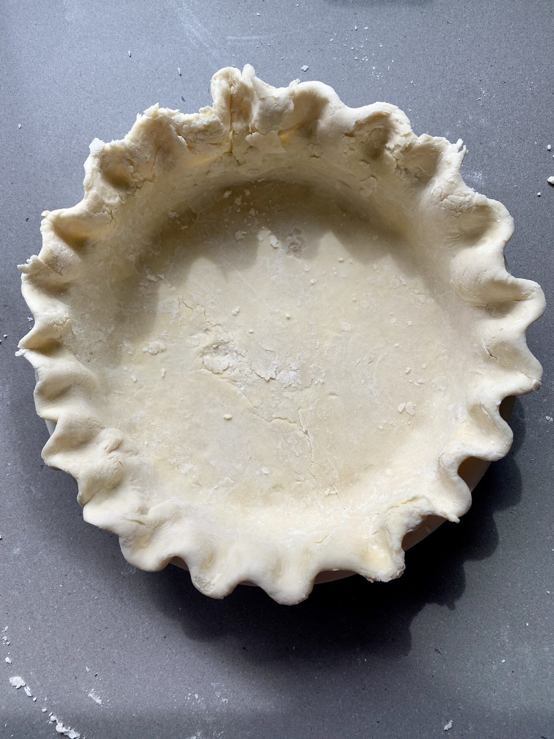 pie dough in pie plate, edges fluted.