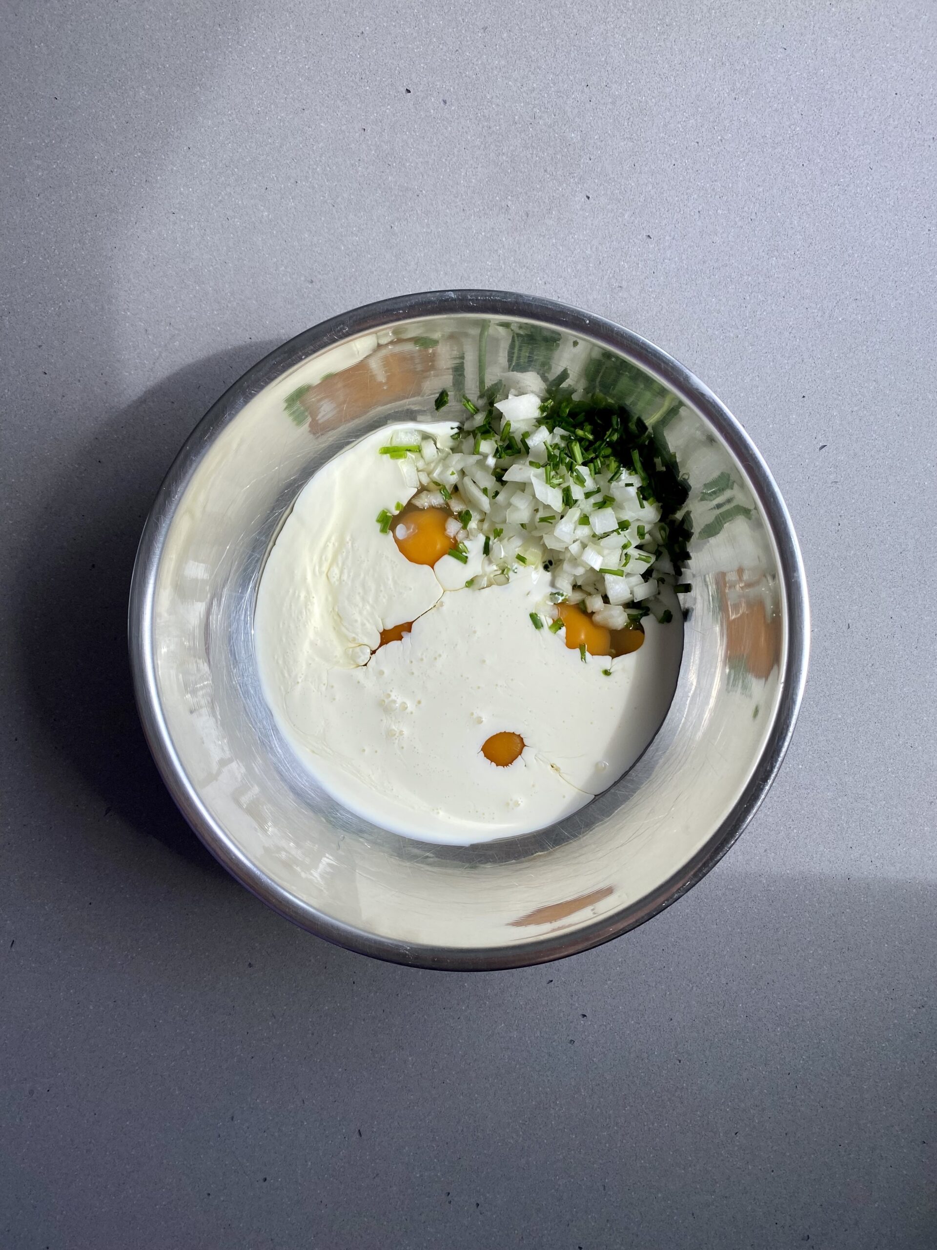 wet ingredients with cream added in a small bowl.