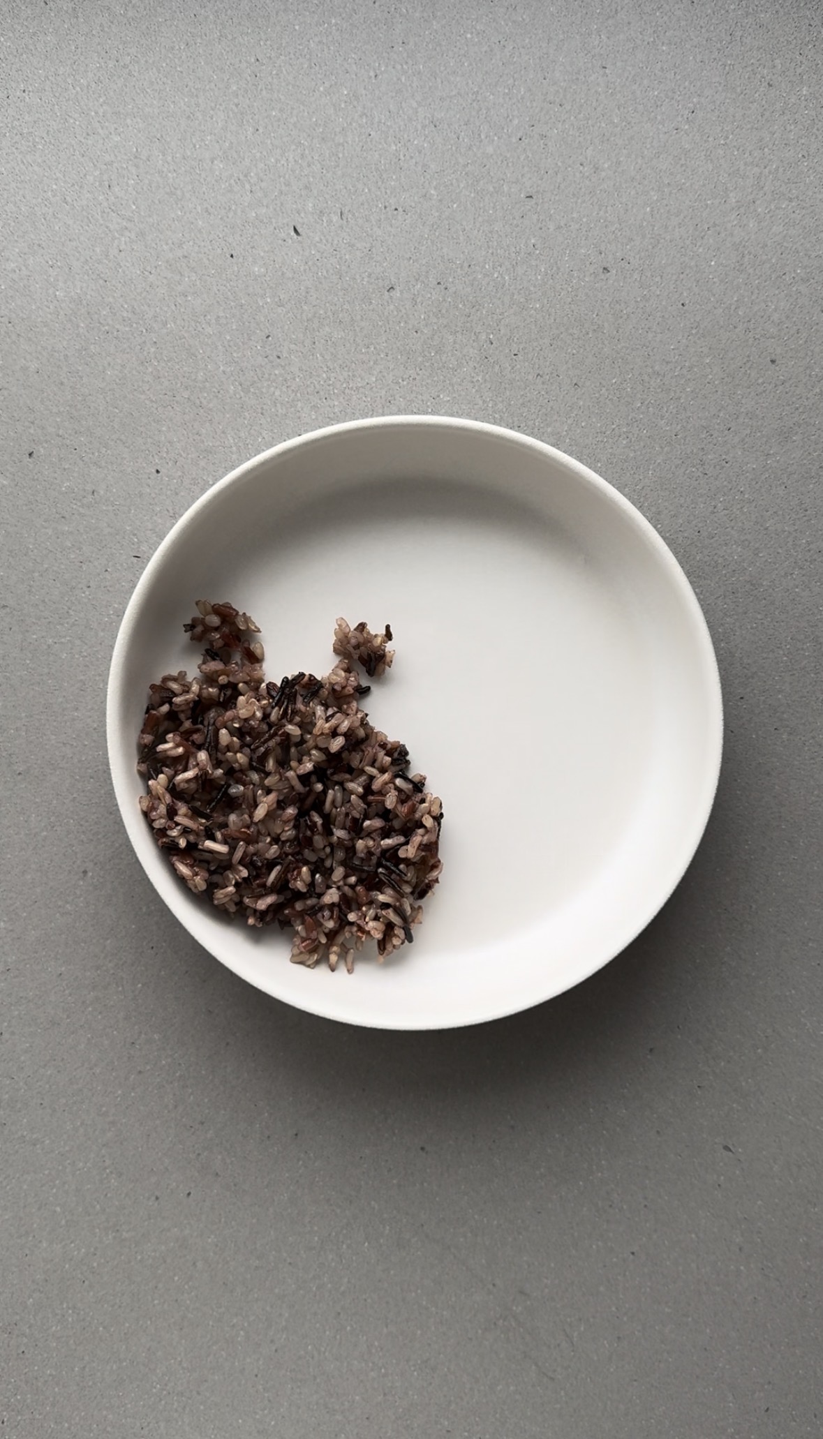 wild rice added to a white bowl.