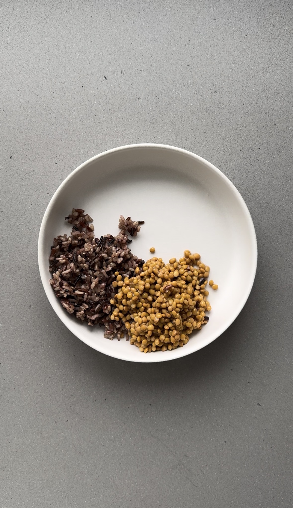 lentils added to a white bowl.