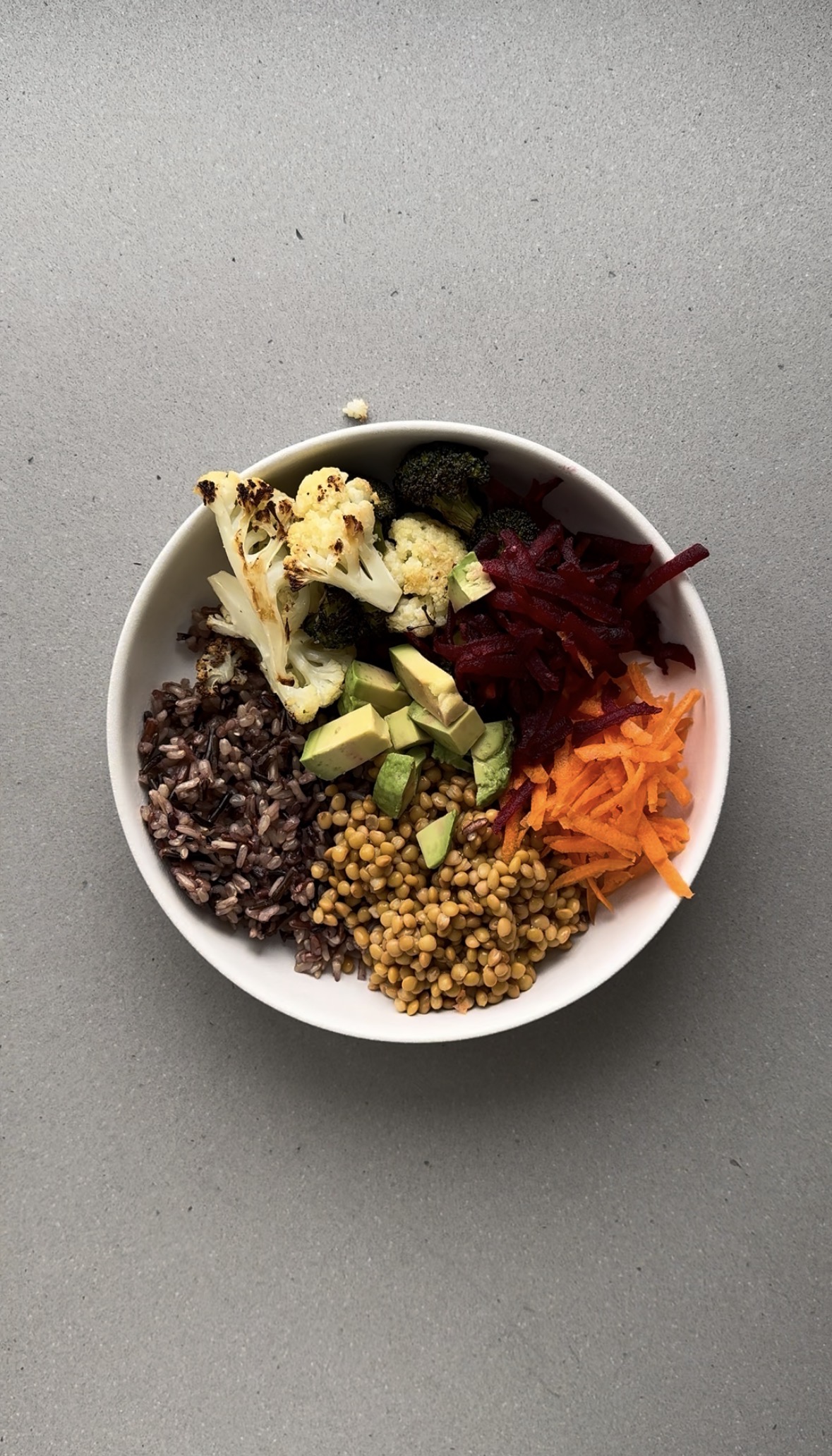 diced avocado added to a white bowl.