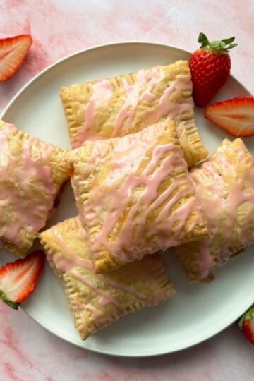 puff pastry pop tarts stacked on a white plate.
