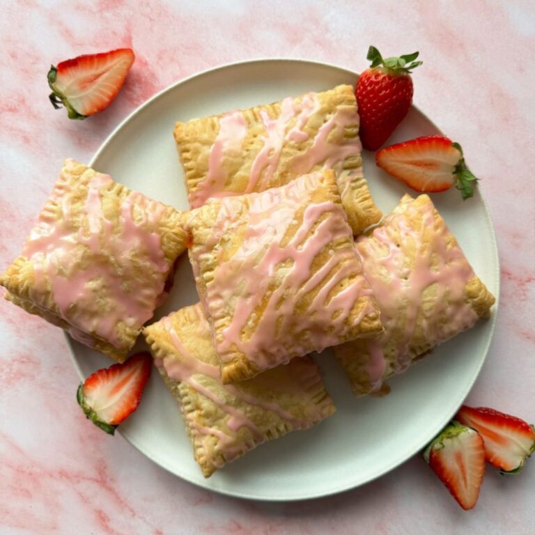puff pastry pop tarts stacked on a white plate.
