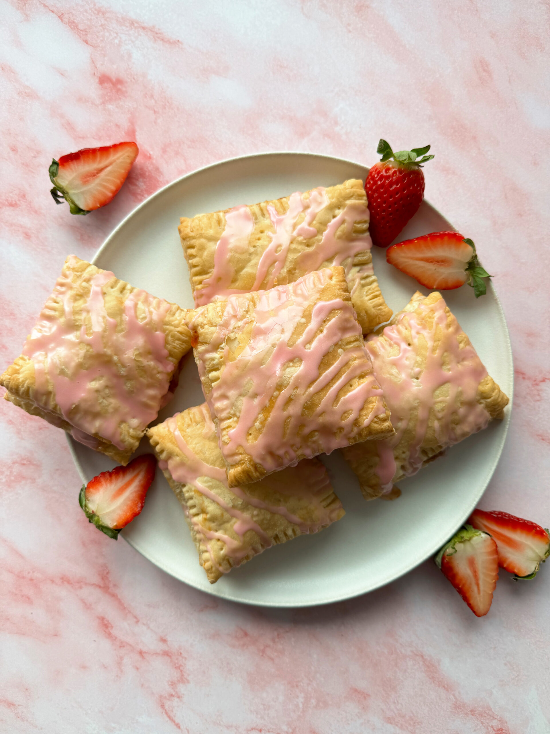 puff pastry pop tarts on white plate.