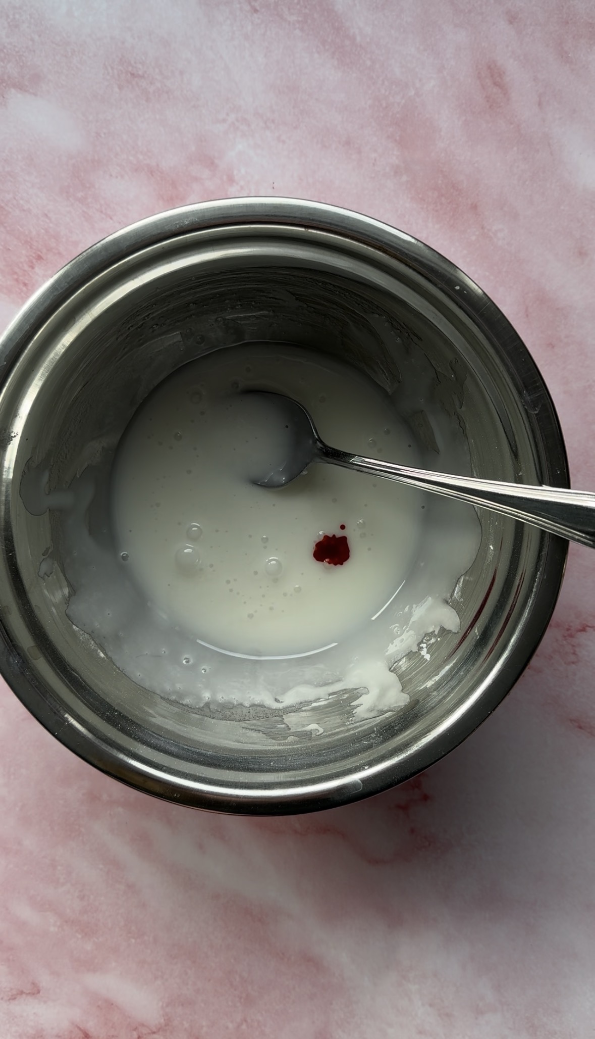 icing in a small bowl with 1 drop of red food colouring.
