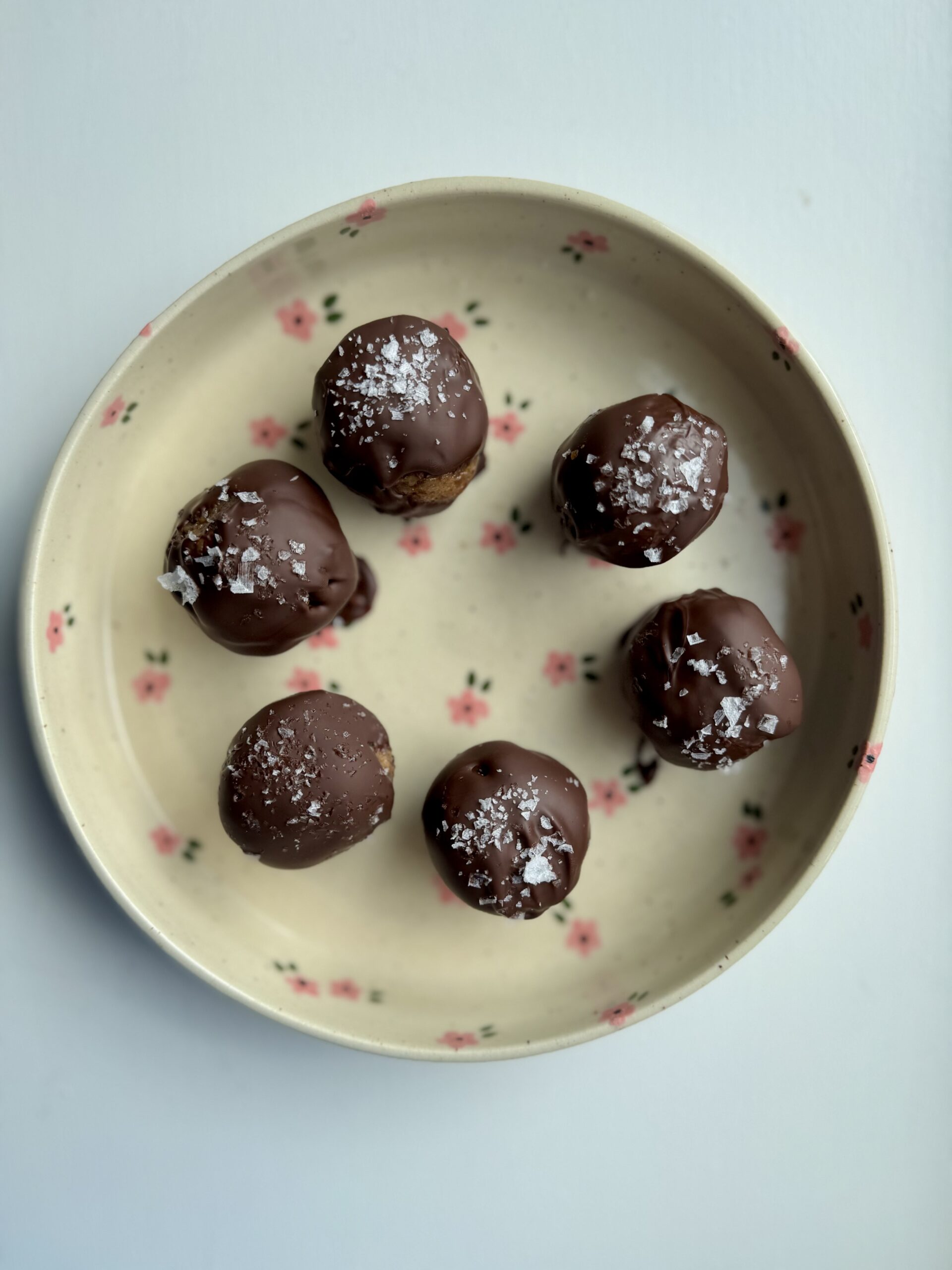 peanut butter date balls on a plate.