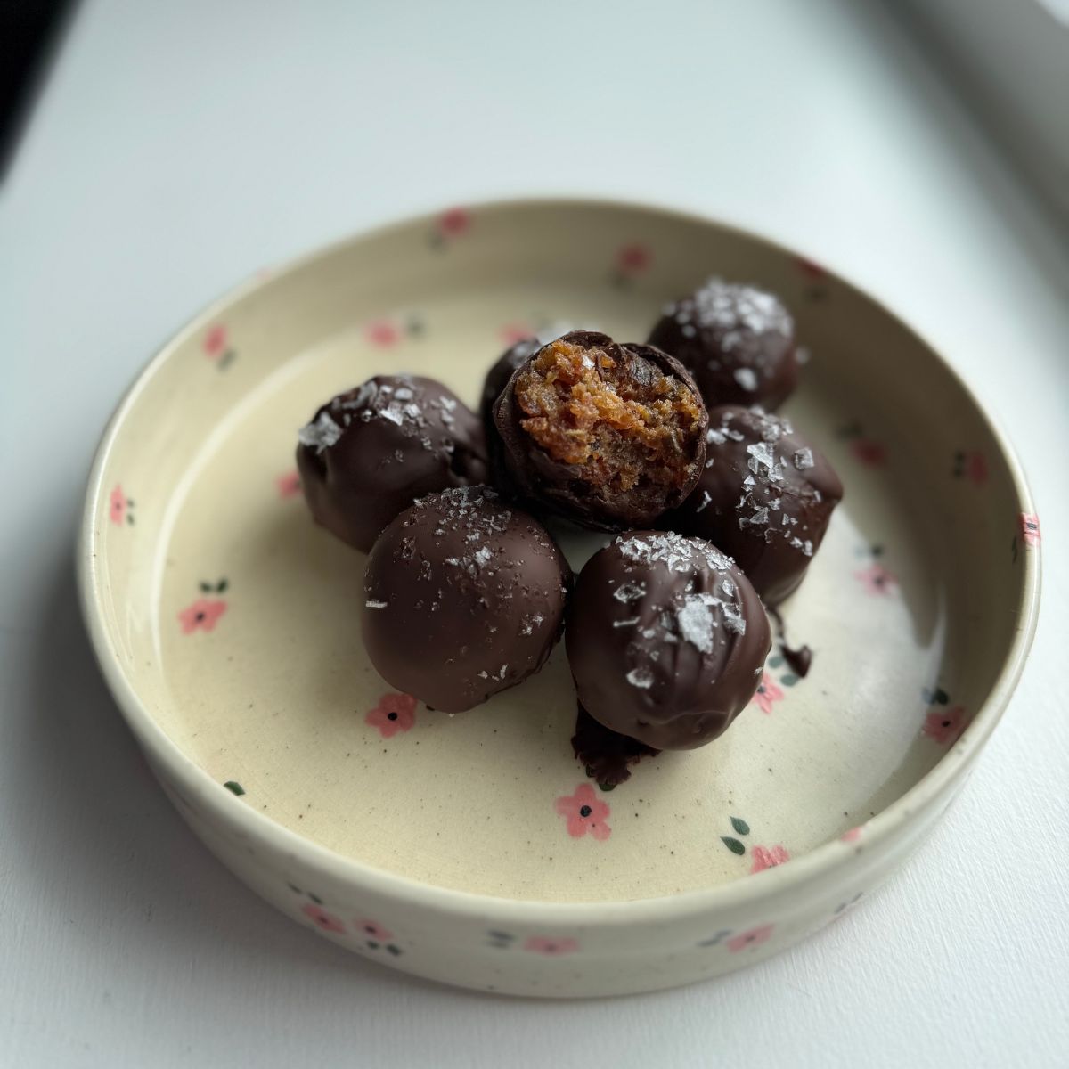 peanut butter date balls on a plate.