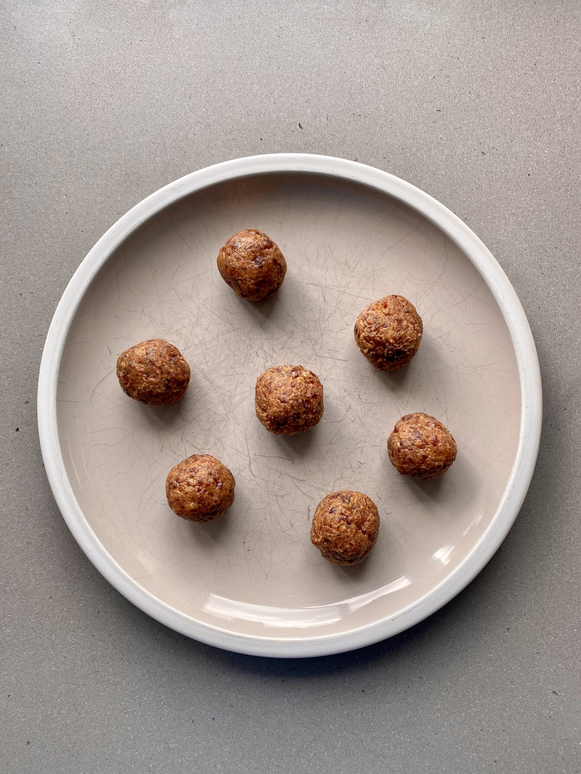 seven balls rolled and on a plate.