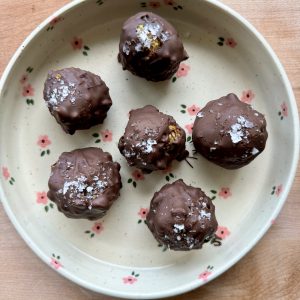 6 peanut butter date balls on a flower plate