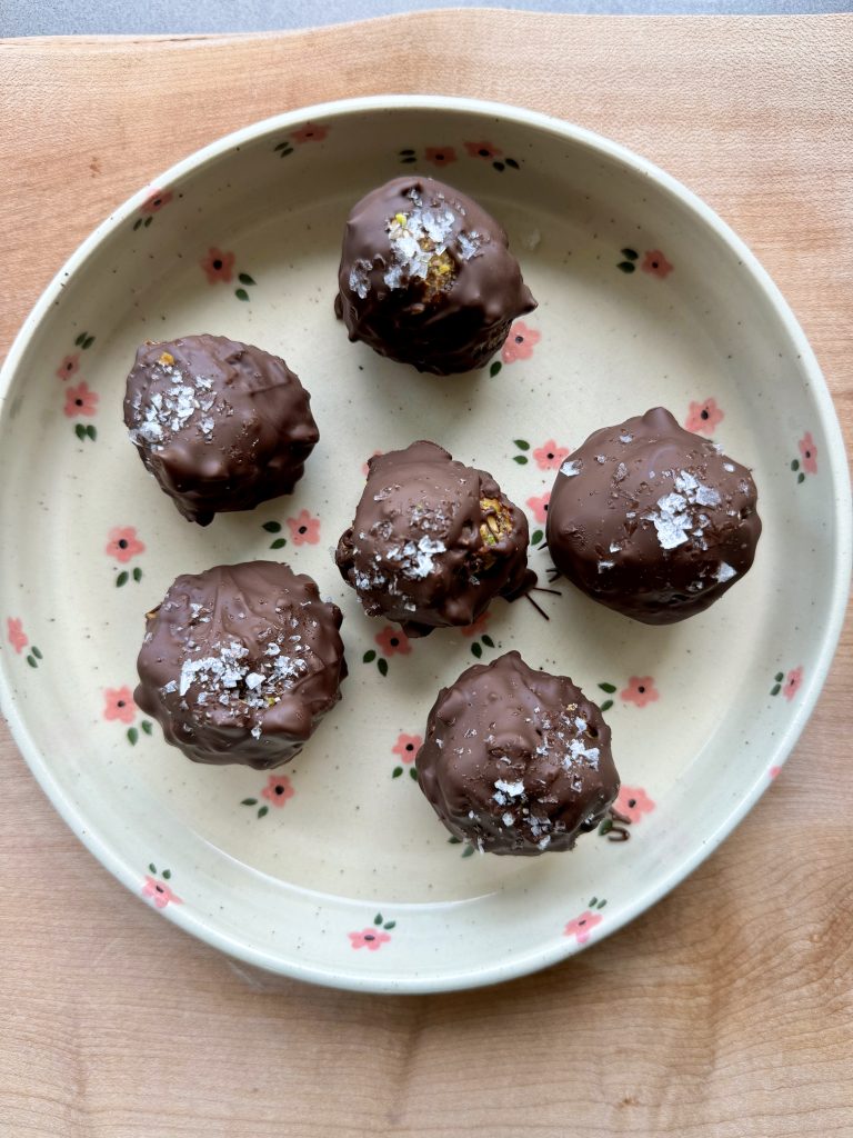 6 peanut butter date balls on a flower plate