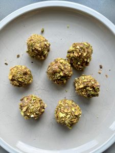peanut butter date balls rolled in chopped pistachios