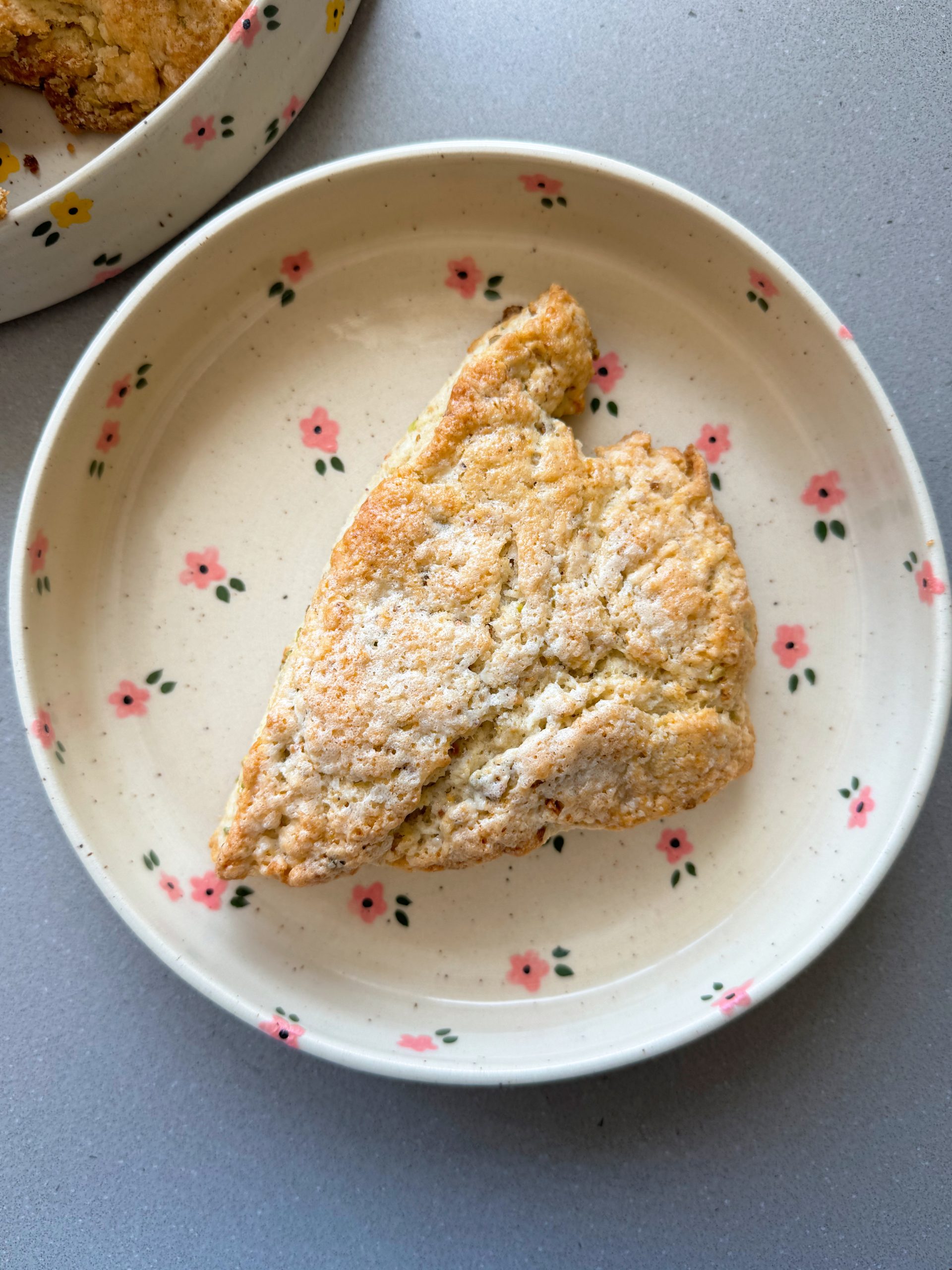 Pistachio scones on flower plate white chocolate pistachio scone on a pink flower plate