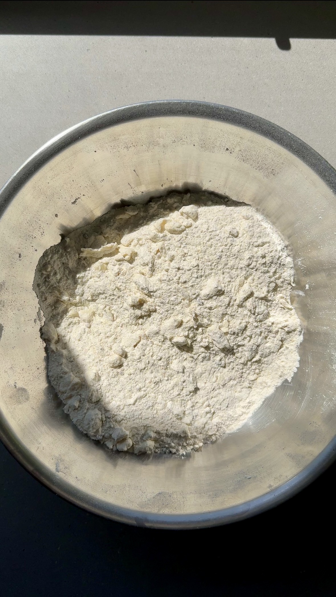 butter and dry ingredients combined in a bowl.