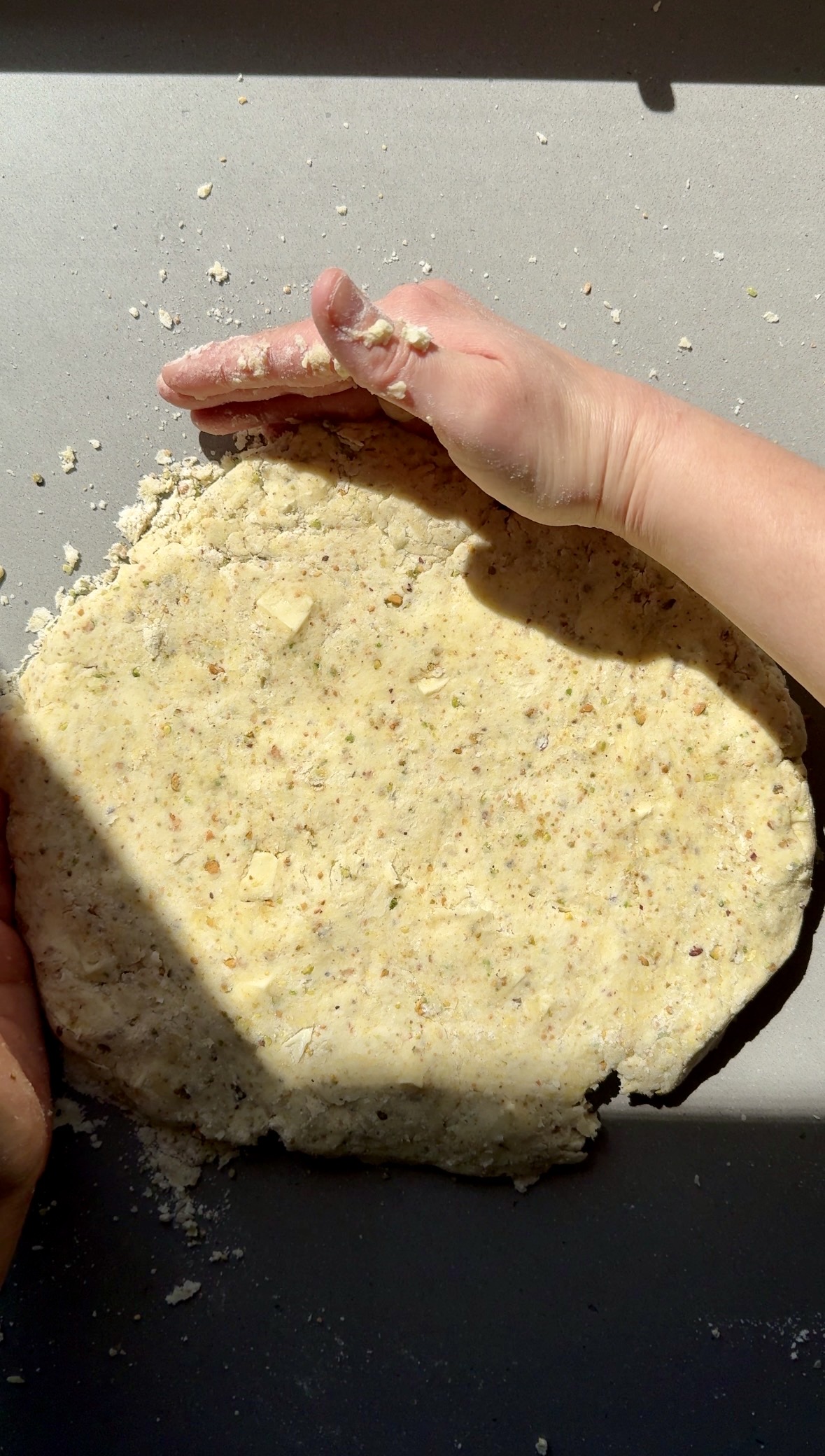 scone dough being shaped on a counter.