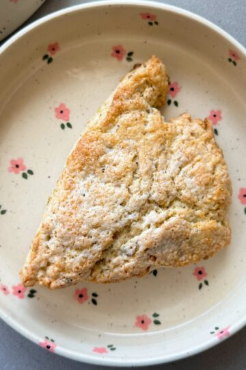 pistachio white chocolate scone on a plate.