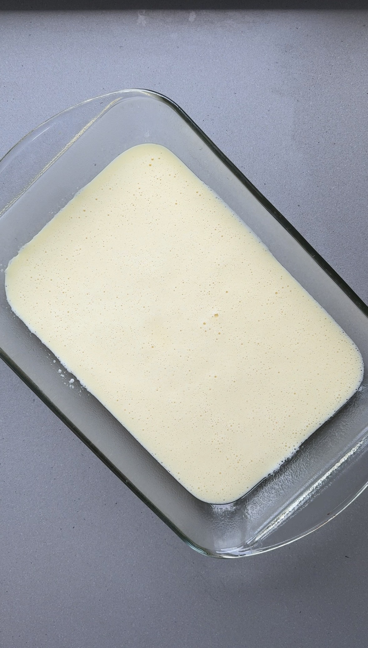 blended eggs and cottage cheese in a glass baking dish.