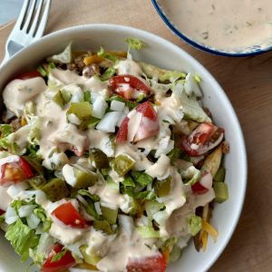 vegetarian big mac loaded fries in a white bowl