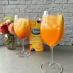 mango passionfruit spritz in wine glasses