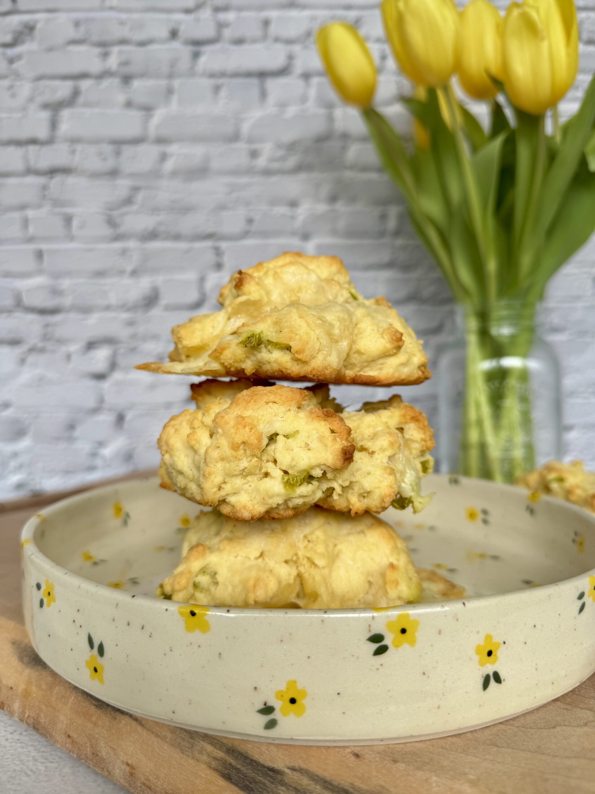 cheese drop biscuits staked on a plate.