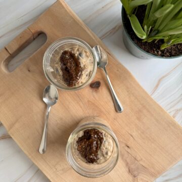 muesli in mason jars on wooden cutting board